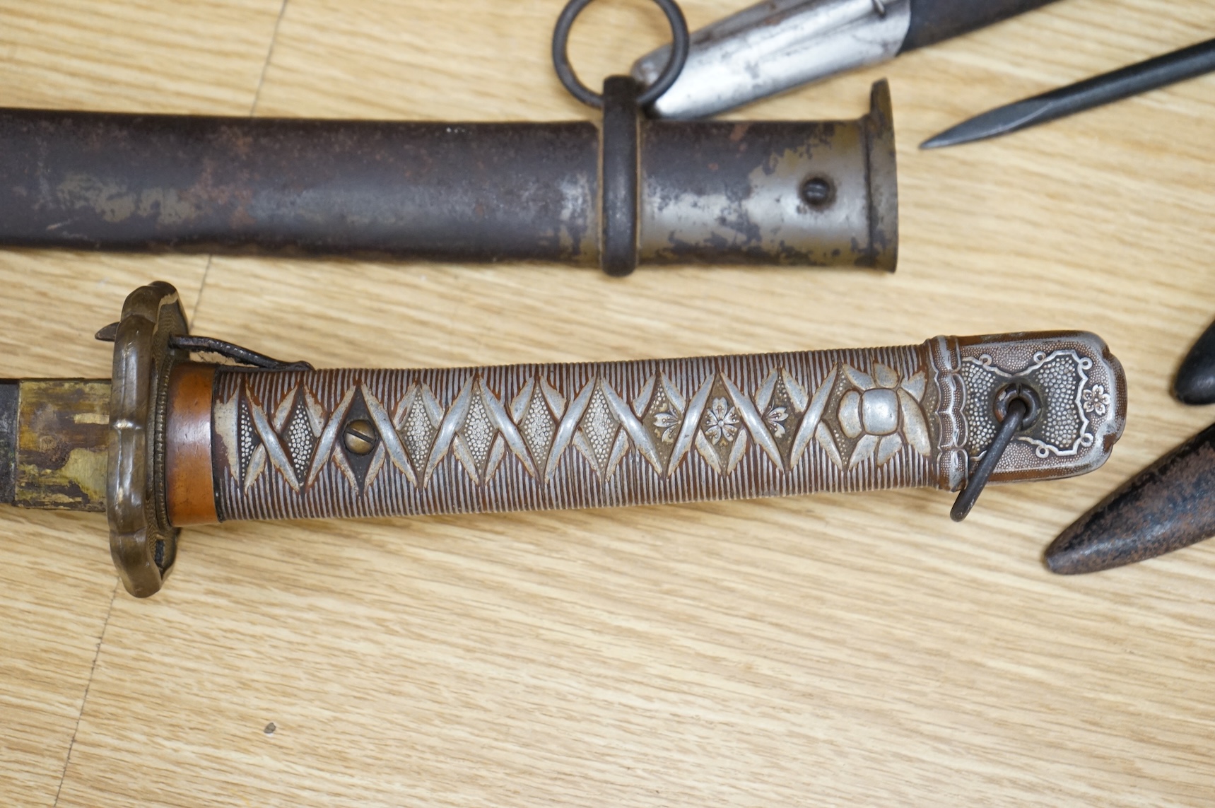 A Japanese World War II NCO‘s sword katana, regulation blade with fuller, stamped 33271, regulation aluminium hilt, brass guard, the spring catch still retains, in an iron scabbard